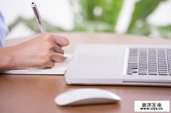 Businesswoman clicking the mouse and writing documents
